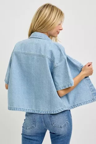 Back view: oversized cropped light-wash denim shirt with short half sleeves