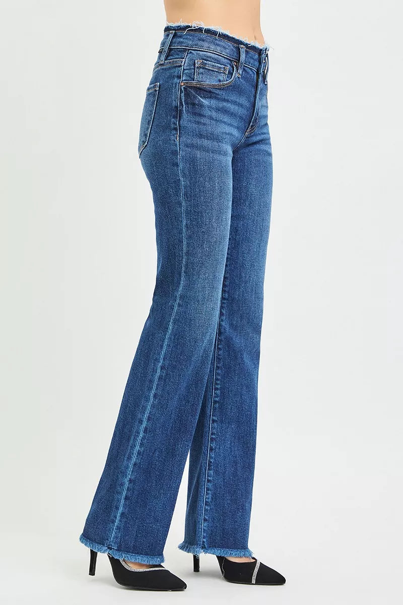 Side view dark blue bootcut jeans with contrast stitching and frayed cuffs