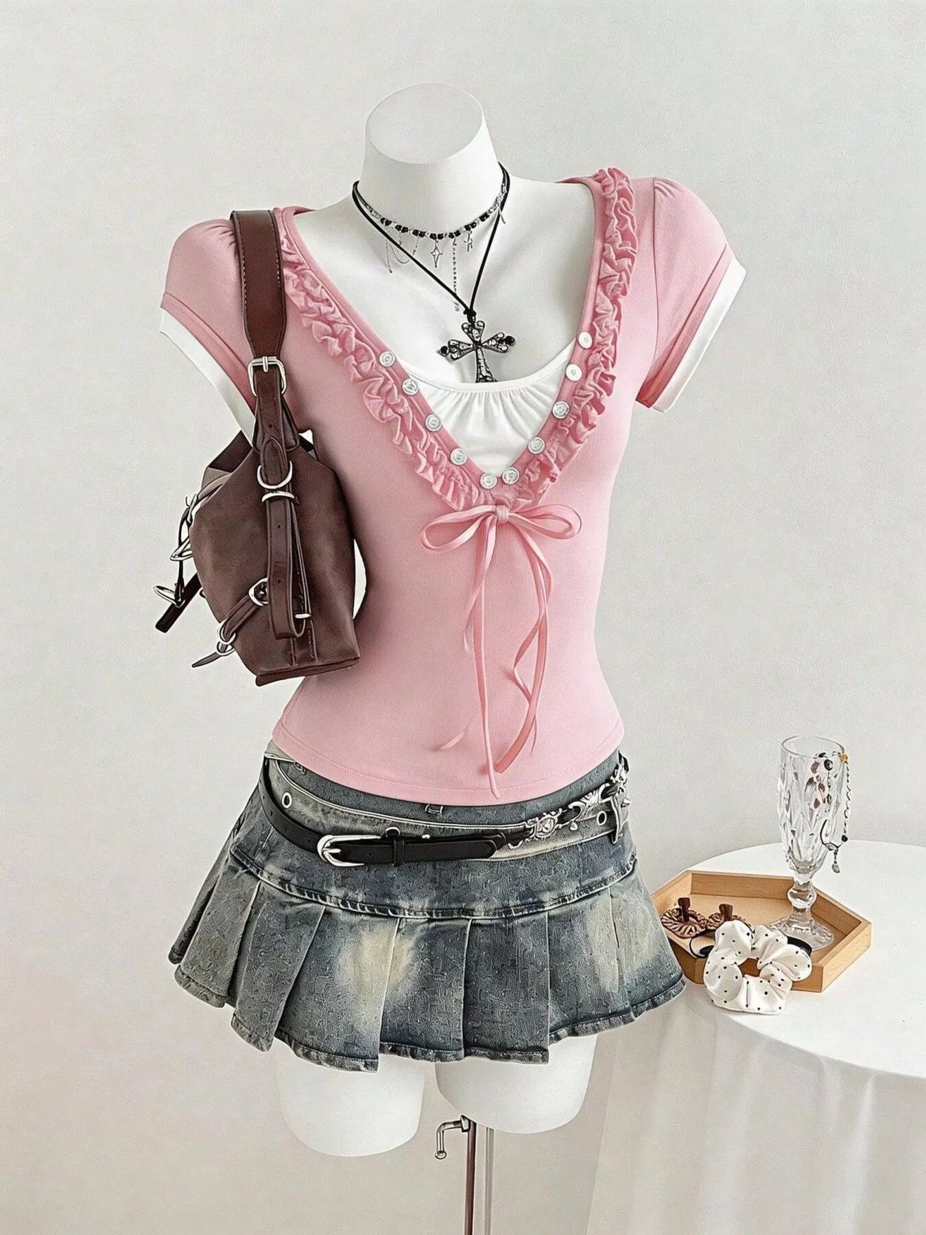 Pink slim fit T-shirt with frill cap sleeves and buttoned ruffle neckline