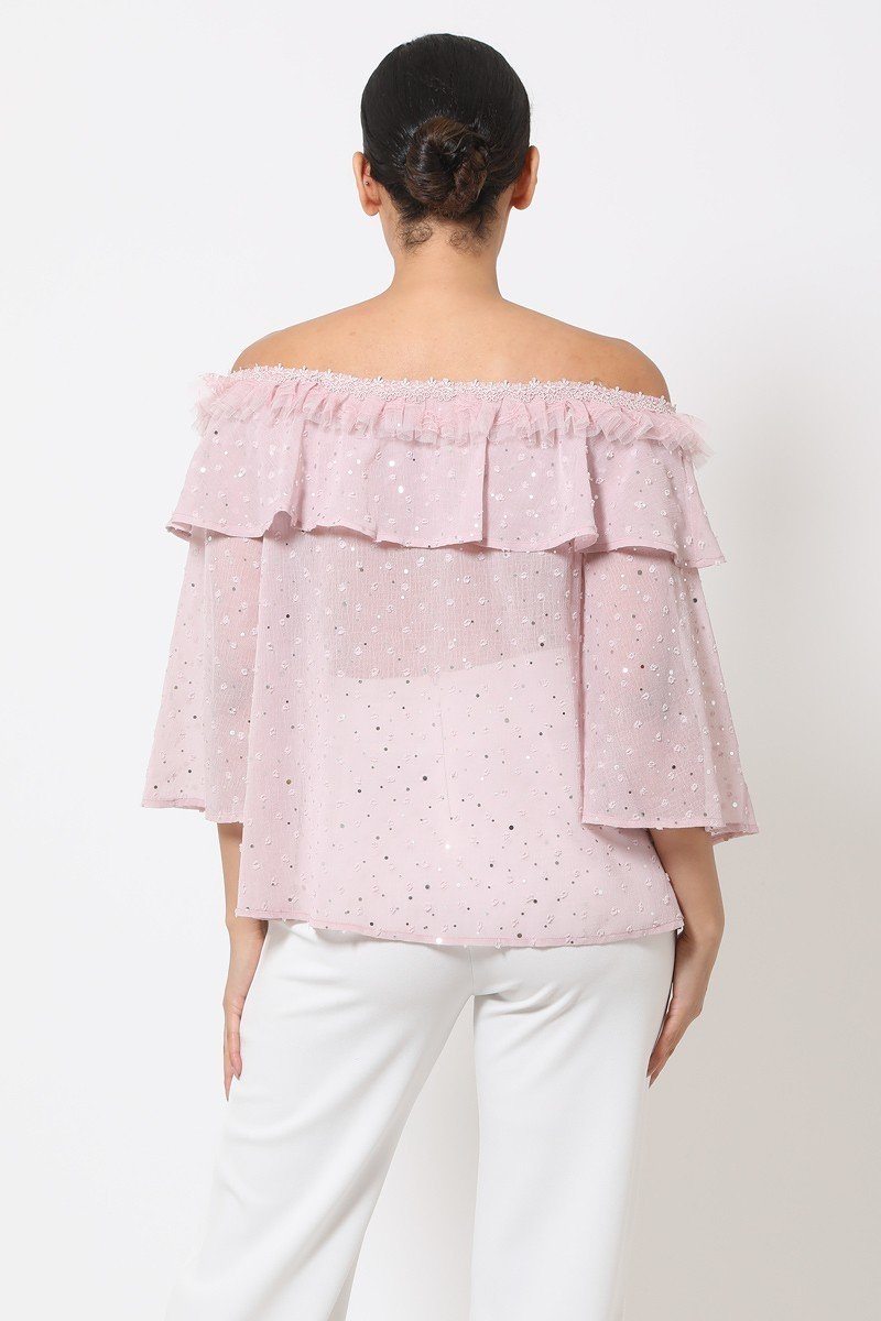 Back view: mauve sheer off-shoulder polka dot top with ruffled upper yoke
