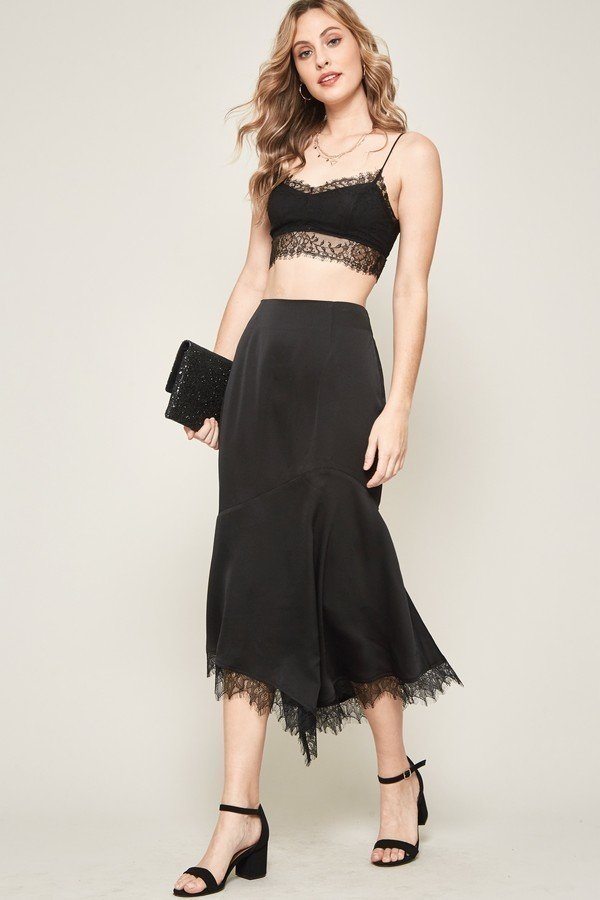 Solid woven midi skirt (black) with asymmetrical drape and lace-edged hem