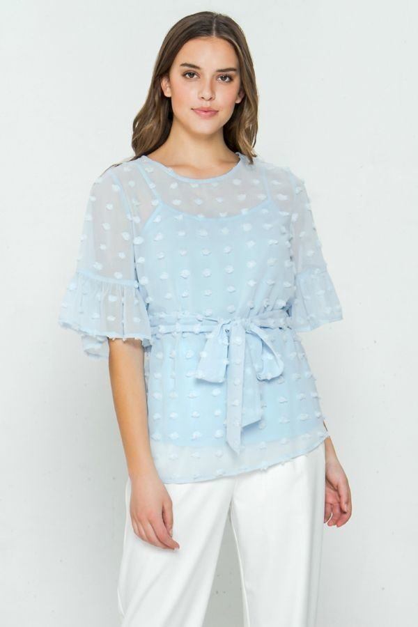 Light blue pom-pom patterned top with ruffled bell sleeves and tied waist