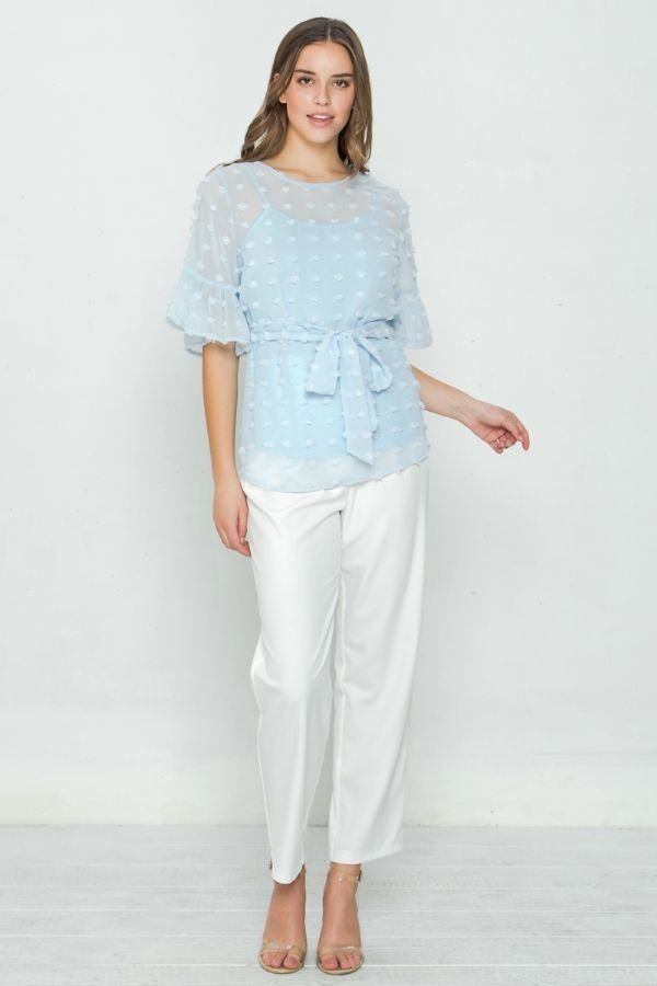 Light blue blouse with short puff sleeves, layered ruffle hem, and waist tie