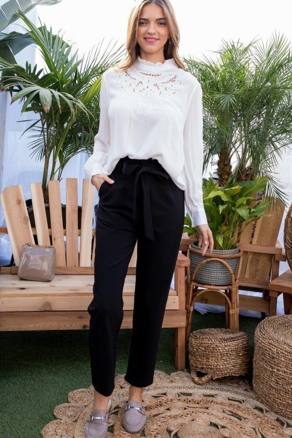 Black high-waist pants with ruffle belt, side pockets, and front zipper.