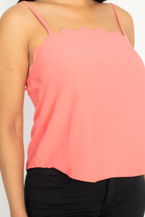 Close-up of coral scalloped neckline on cami top with thin straps