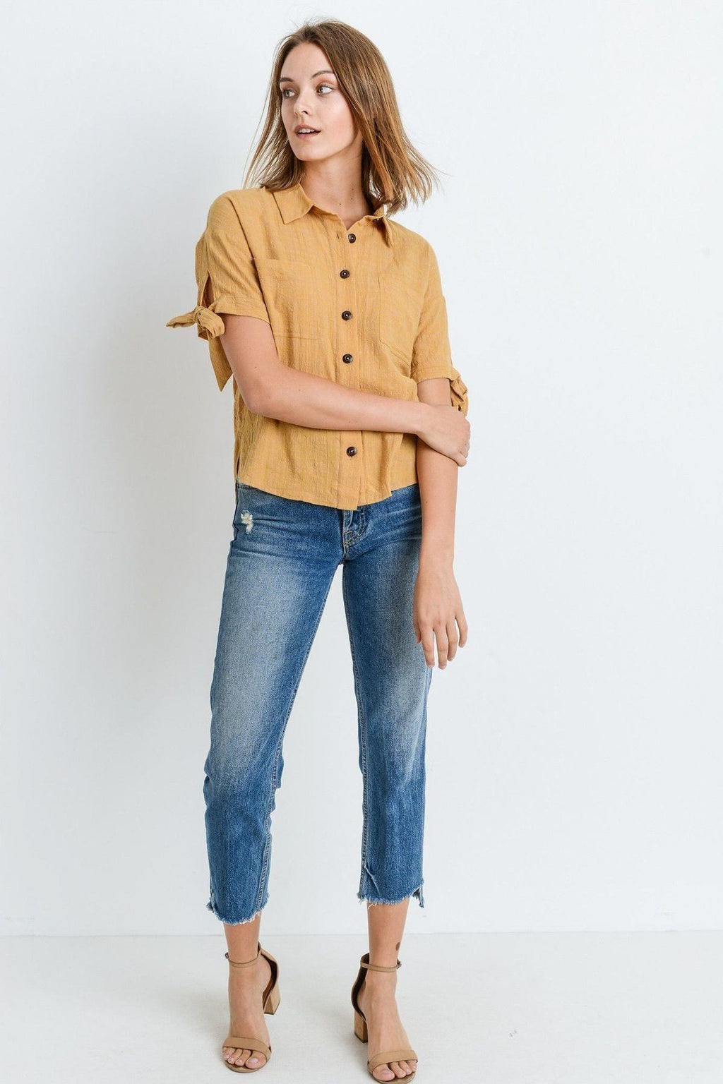 Mustard button-up short sleeve blouse with tied sleeve cuffs and front buttons