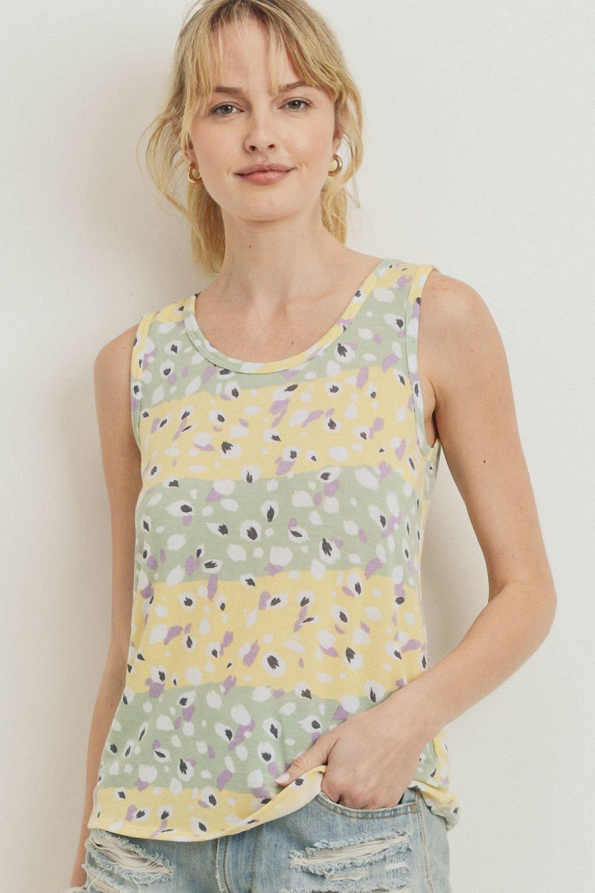 Printed sleeveless terry top with yellow floral pattern and round neckline
