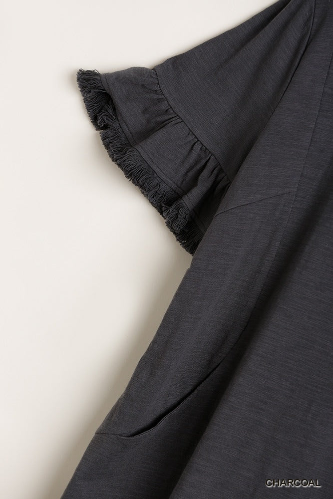 Charcoal dress close-up: ruffle sleeve and side pocket, frayed trim