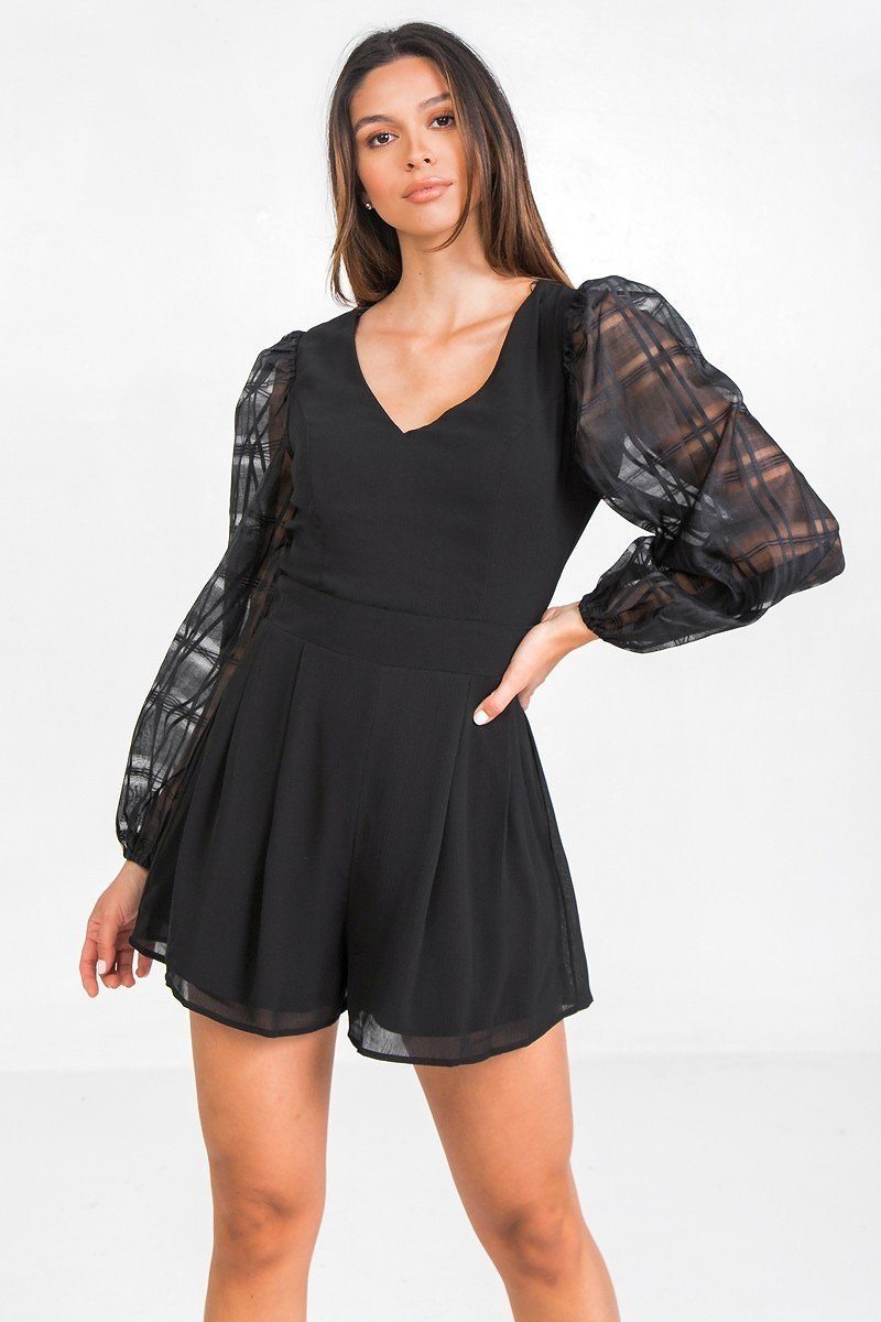 Black V-neck romper with pleated skirt and sheer plaid puff sleeves