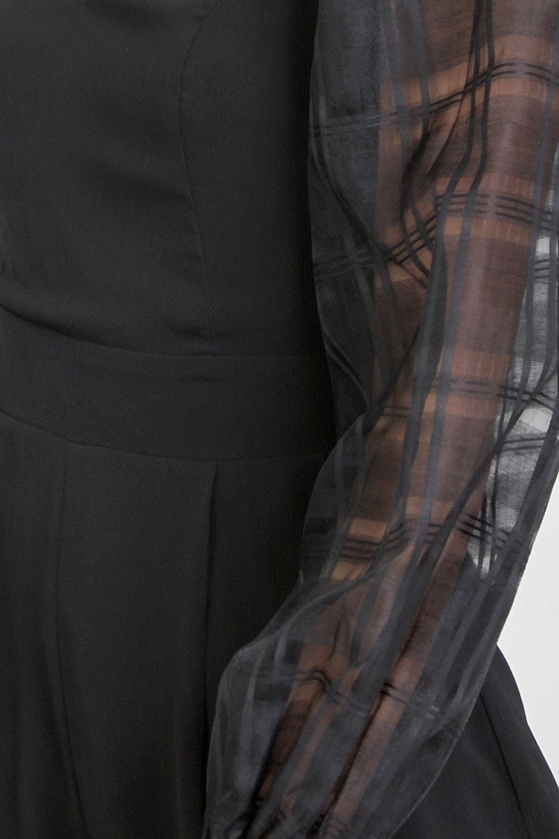 Sheer plaid sleeve overlay on black romper bodice