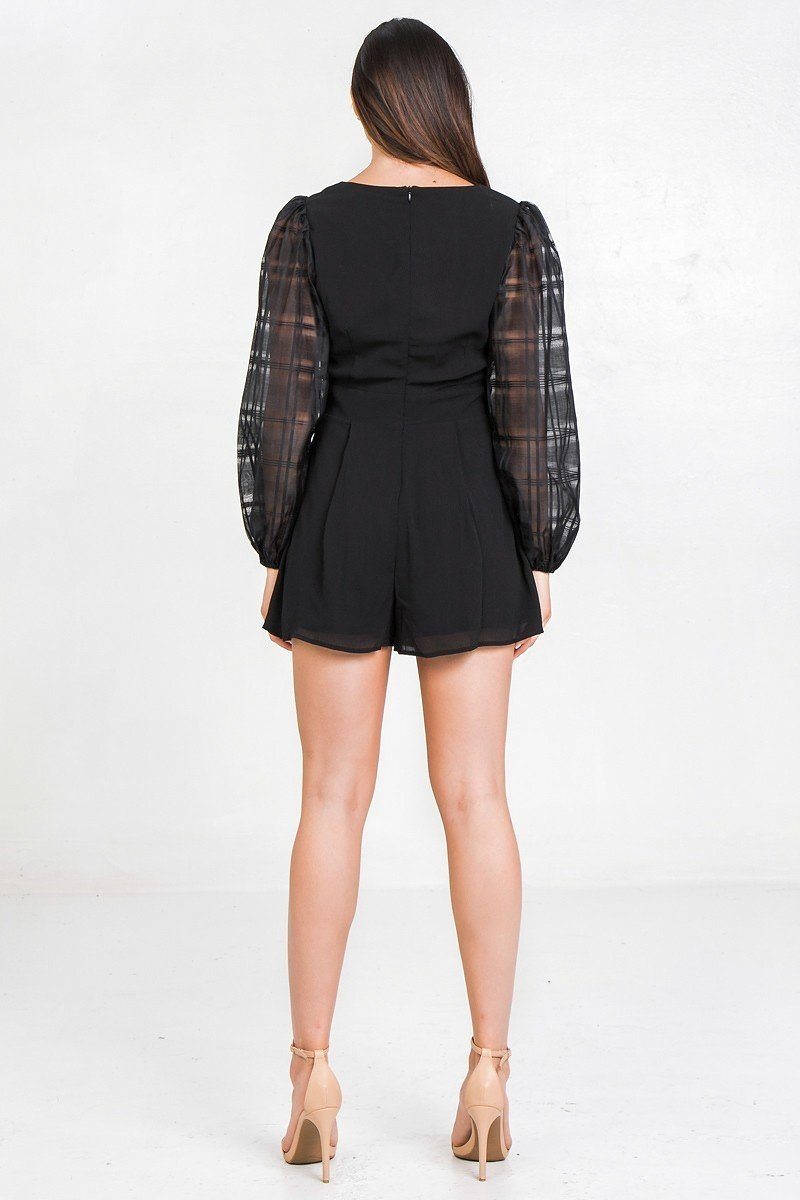 Back view black romper with sheer plaid puff sleeves and short flared legs