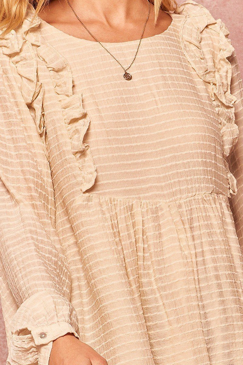 Cream semi-sheer striped woven top close-up with textured stripes and gathered cuffs