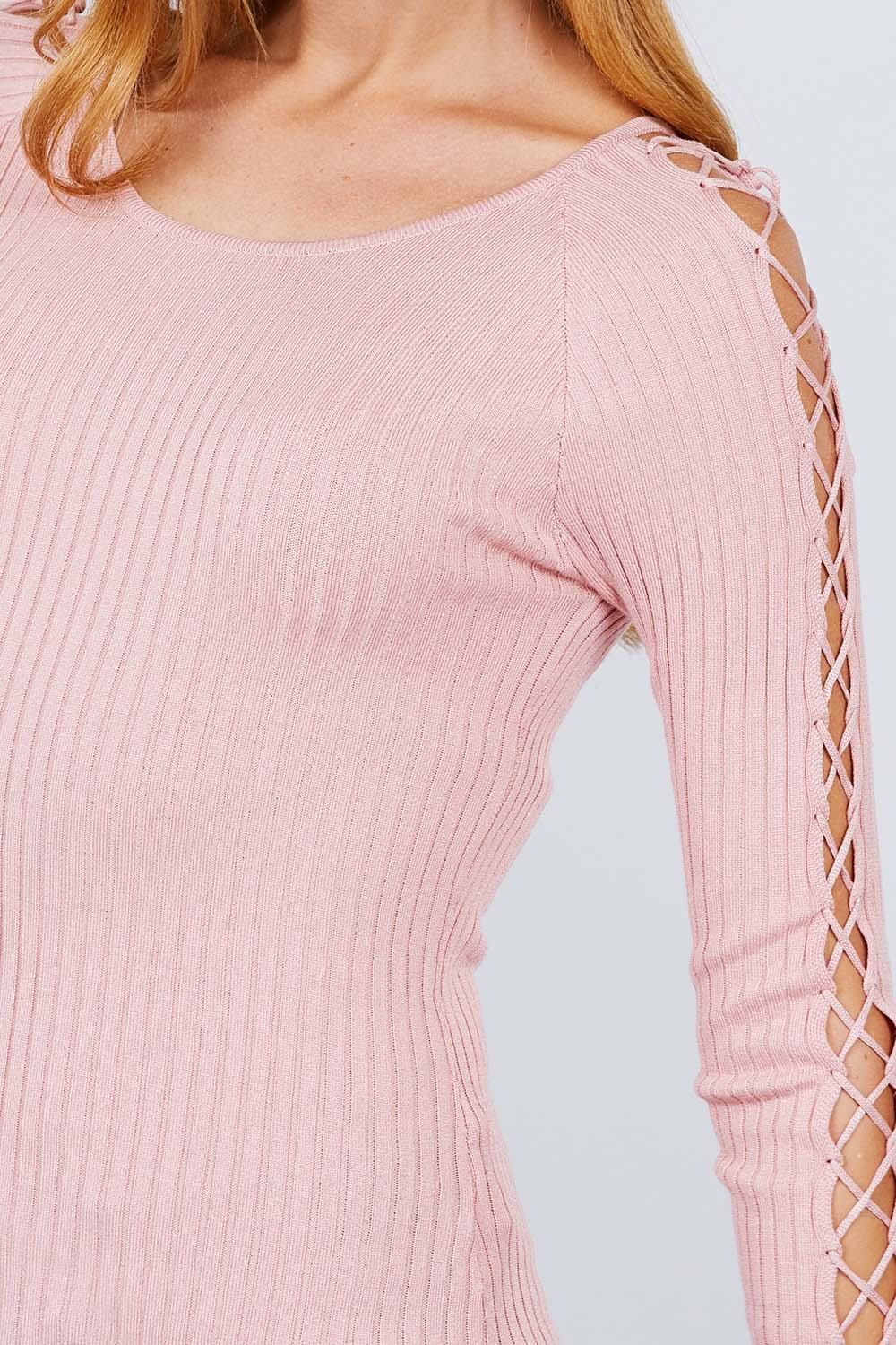 Pink knit top close-up: round neck and crisscross lace-up sleeve panel