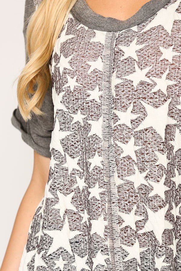 Close-up of gunmetal gray star knit tunic with textured star print front