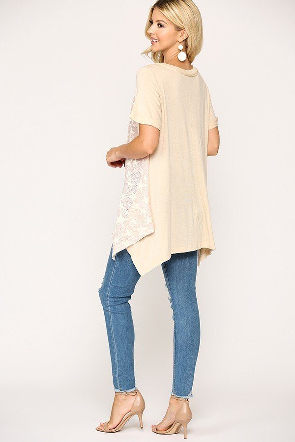 Back view of pale pink/cream star knit tunic with short sleeves and shark-bite hem