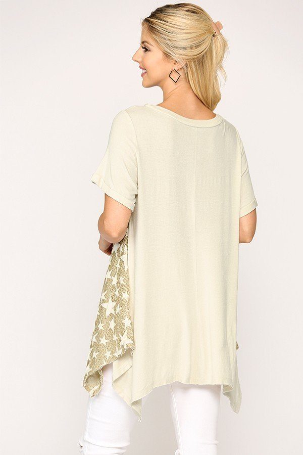 Back view of golden sand star knit tunic with short sleeves and shark-bite hem