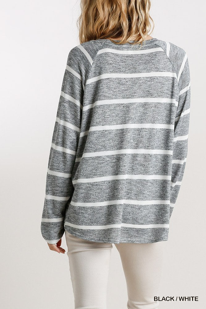 Back view of striped long-sleeve top with round neck, black-and-white horizontal stripes
