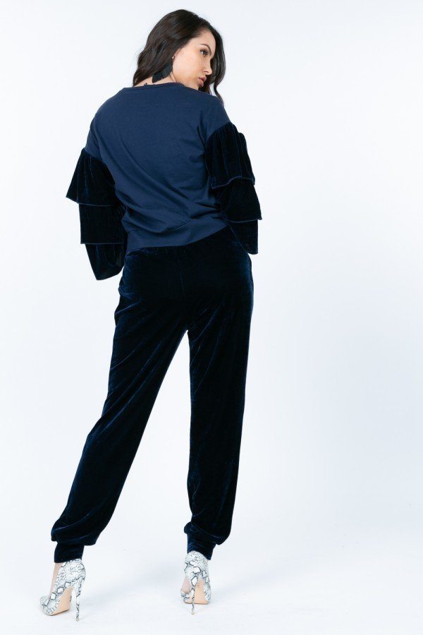 Navy crewneck pullover top with tiered velvet ruffle sleeves (rear view)