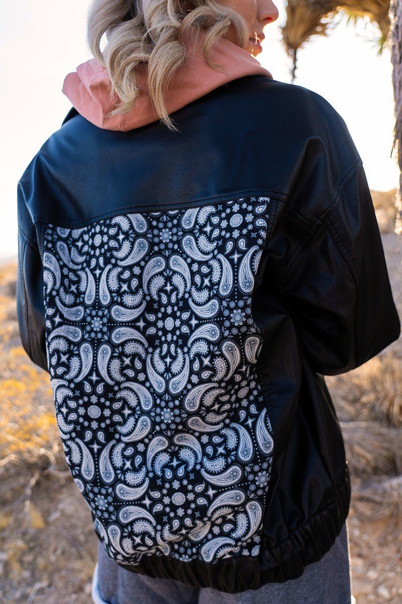 Dark faux leather jacket back shows full paisley print panel and snap pocket