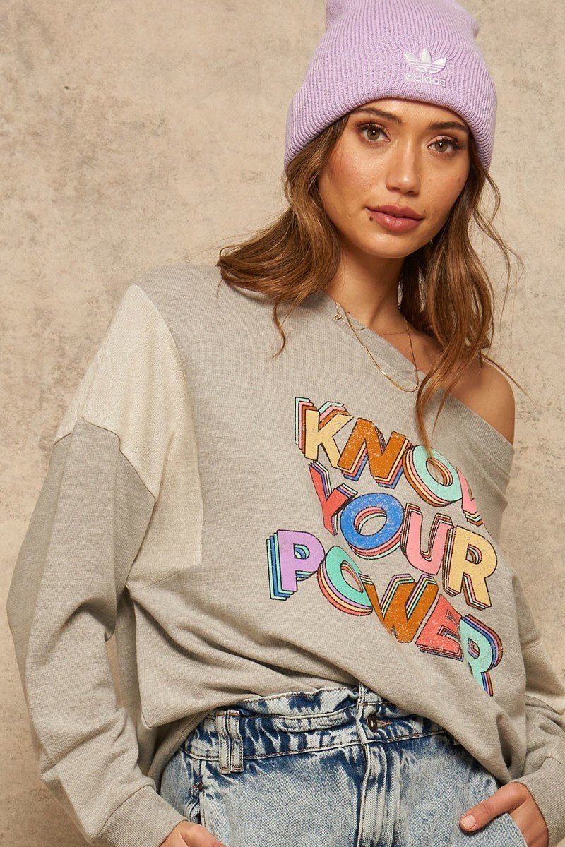 Light gray sweatshirt, dropped-shoulder style, with colorful “KNOW YOUR OWN POWER” graphic
