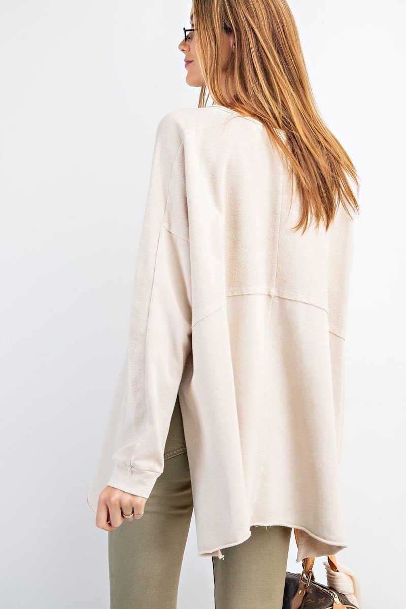Back view of off-white terry knit tunic with curved hem and split sides