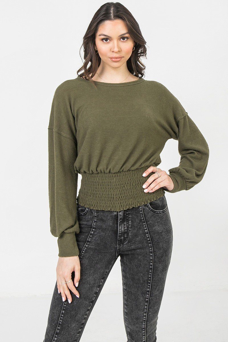 Olive knit top with wide neckline and long balloon sleeves; smocked waist hem