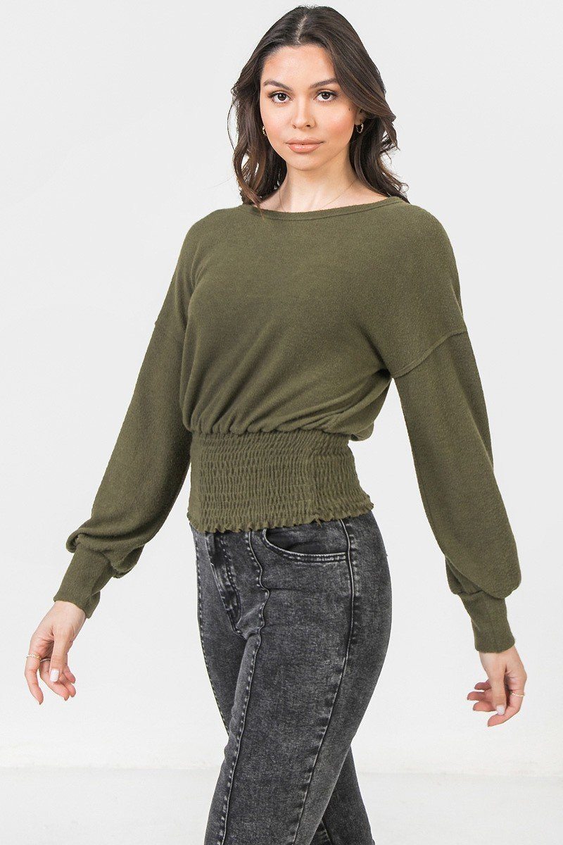 Olive long-sleeve knit top with wide neckline and ruched smocked waist hem