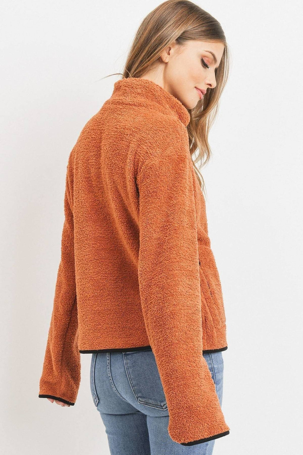 Orange long-sleeve half-zip pullover from the side, fuzzy looped terry texture