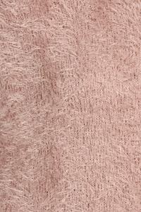 Close-up of dusty pink textured knit fabric with visible speckled yarn texture