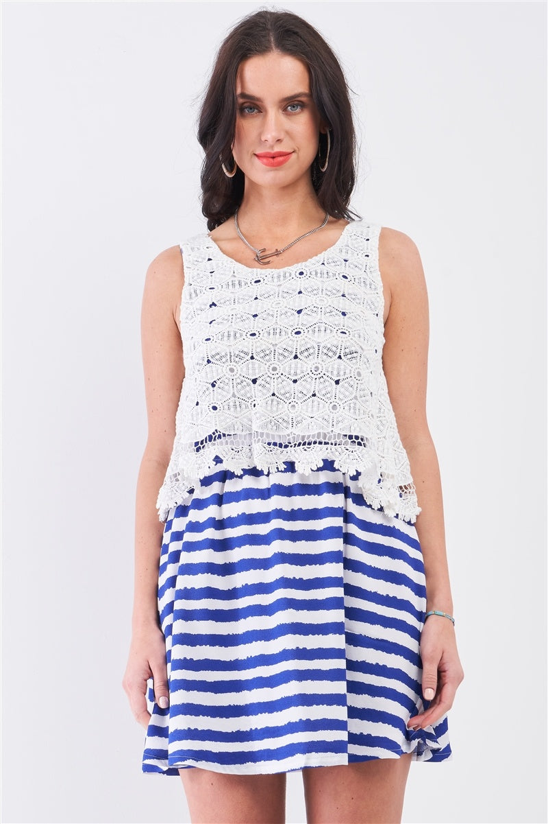 White crochet-style sleeveless top layer with navy/white striped flared mini dress