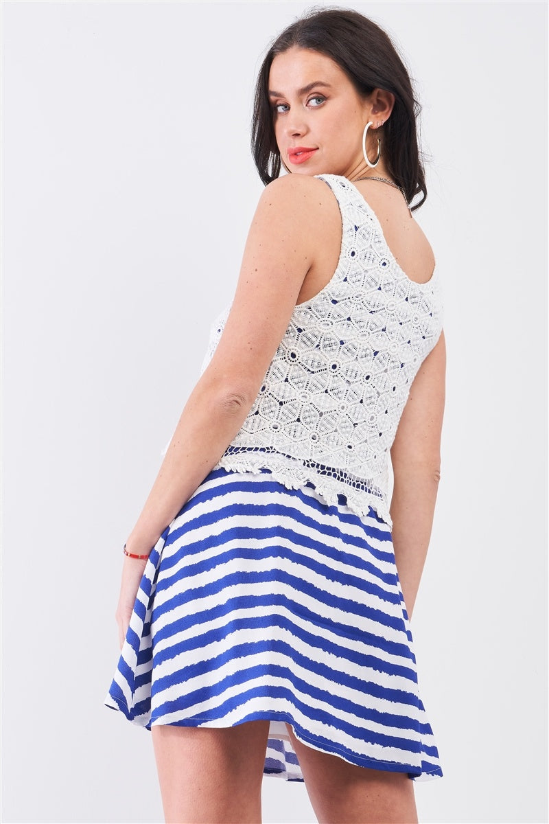 Sleeveless mini dress side view: white crochet bodice and navy-white striped flared skirt