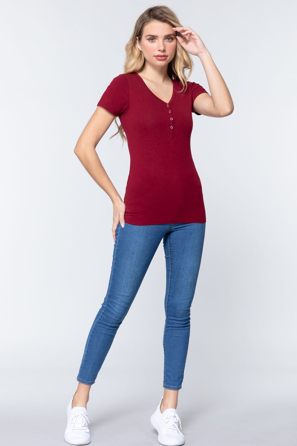Ruby Burgundy V-neck henley knit top with short sleeves, styled with jeans