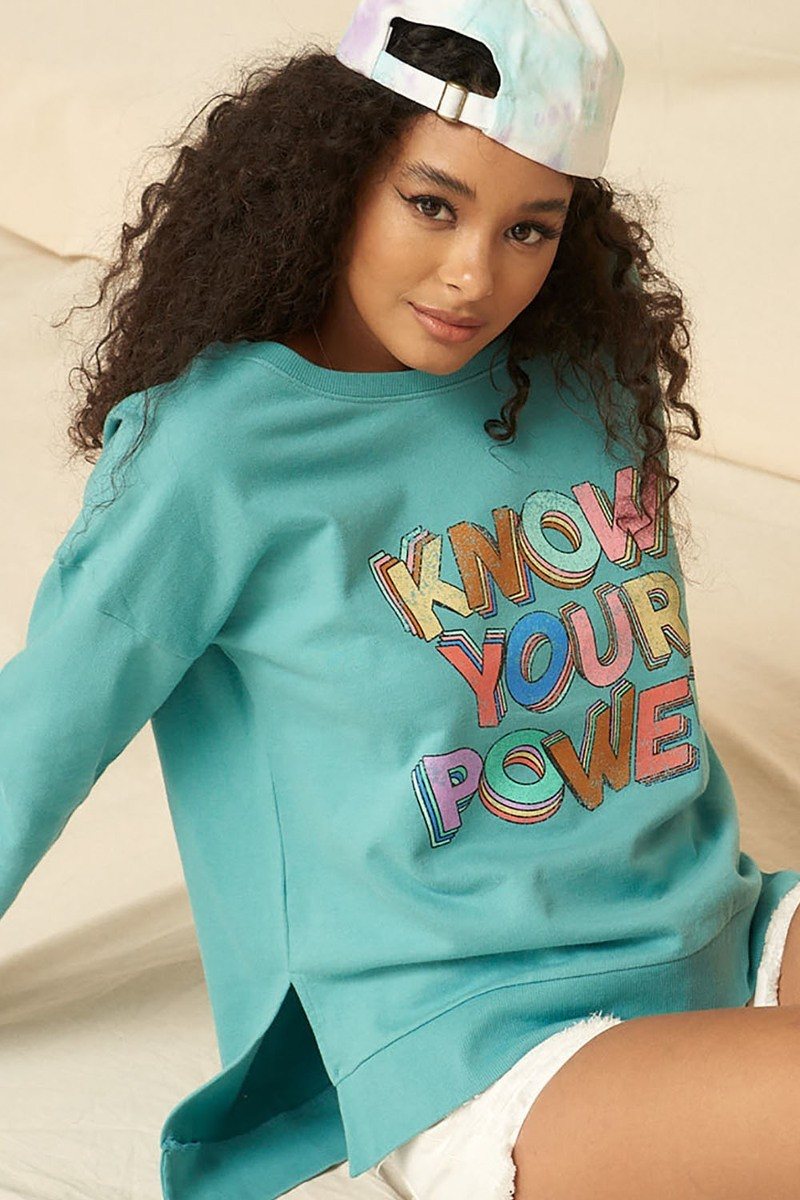 Mineral-washed turquoise sweatshirt with “KNOW YOUR POWER” graphic on the front