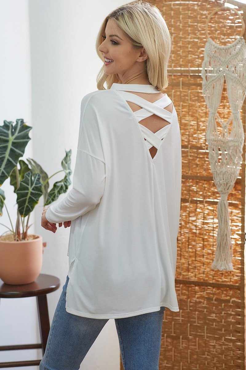 White long-sleeve top with crisscross open back and crossed straps