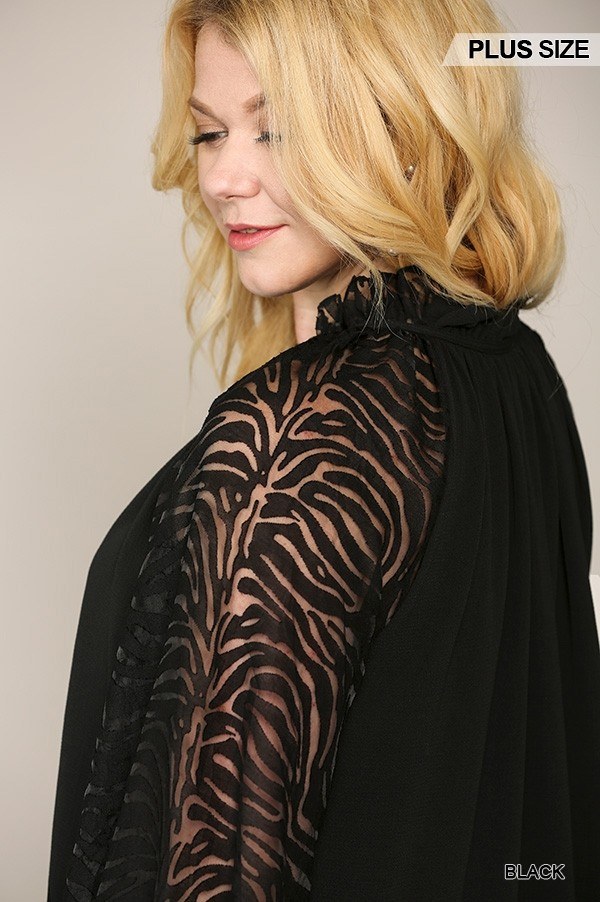 Close-up: black ruffled neck blouse with zebra-pattern sheer sleeves