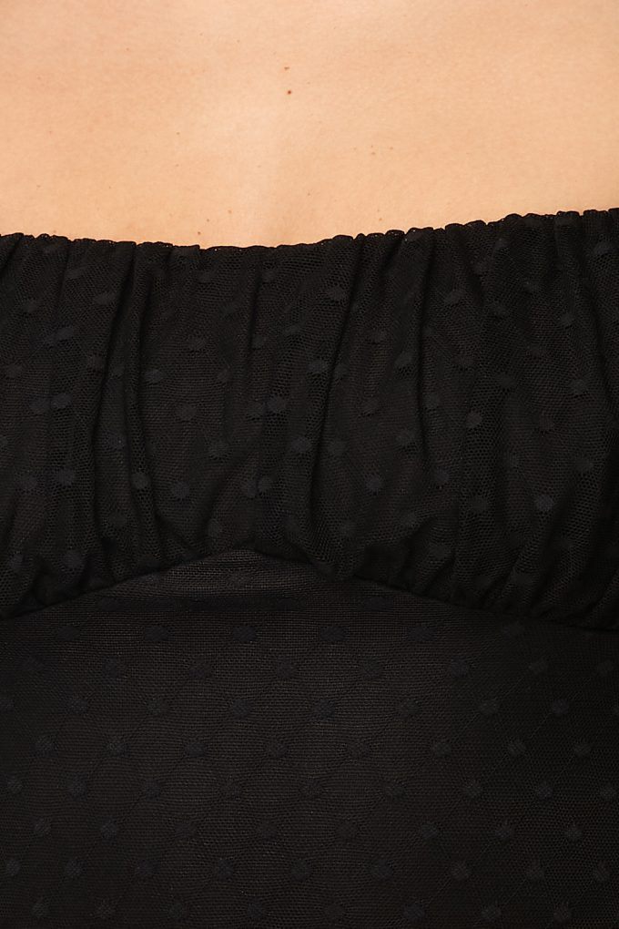 Black polka-dot mesh bodysuit close-up of ruched neckline and gathered fabric