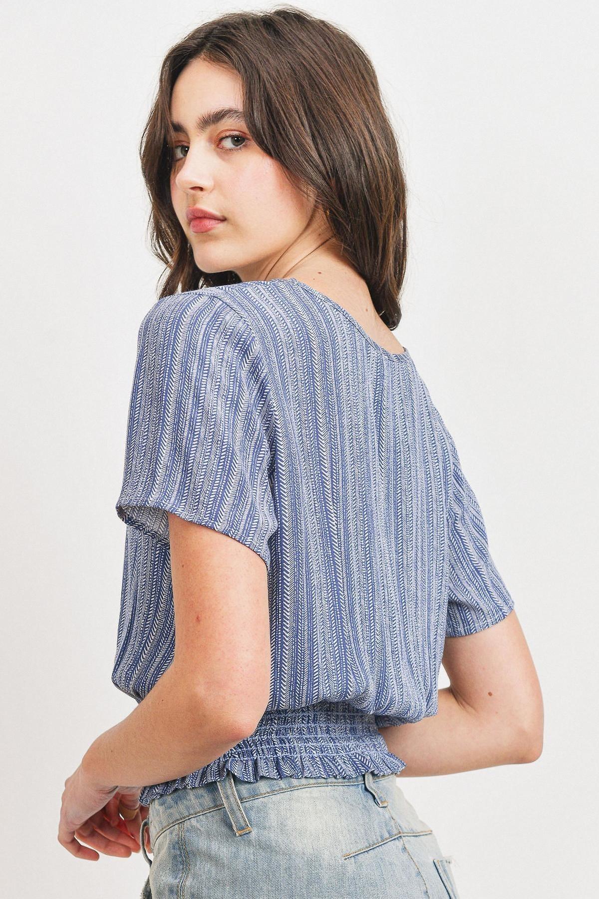 Back view of printed crinkle gauze top with smocked waist and short sleeves, blue