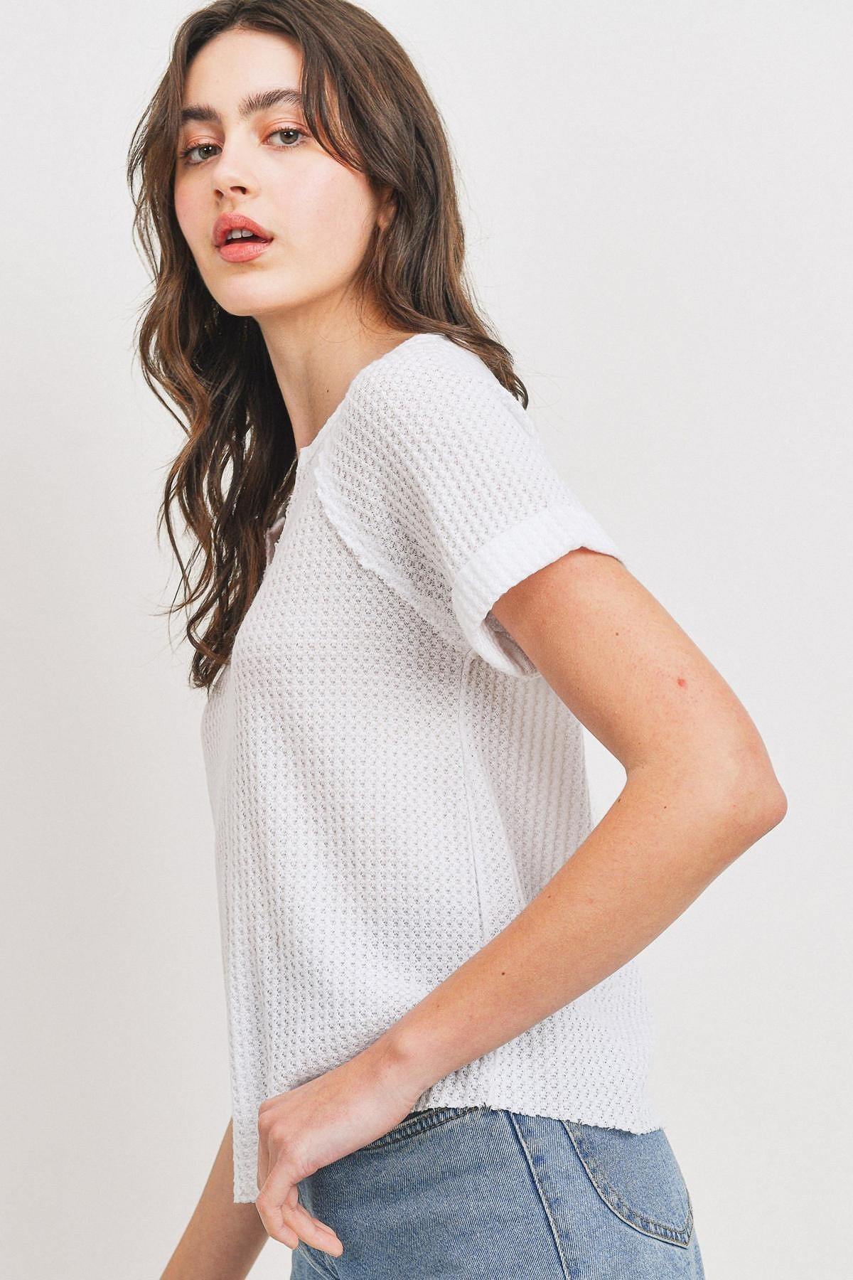 Back/side view white waffle V-neck short-sleeve top with rolled cuffs