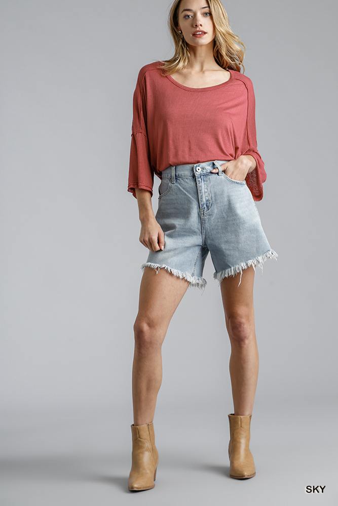 High rise light-wash denim shorts with raw frayed hem, relaxed fit