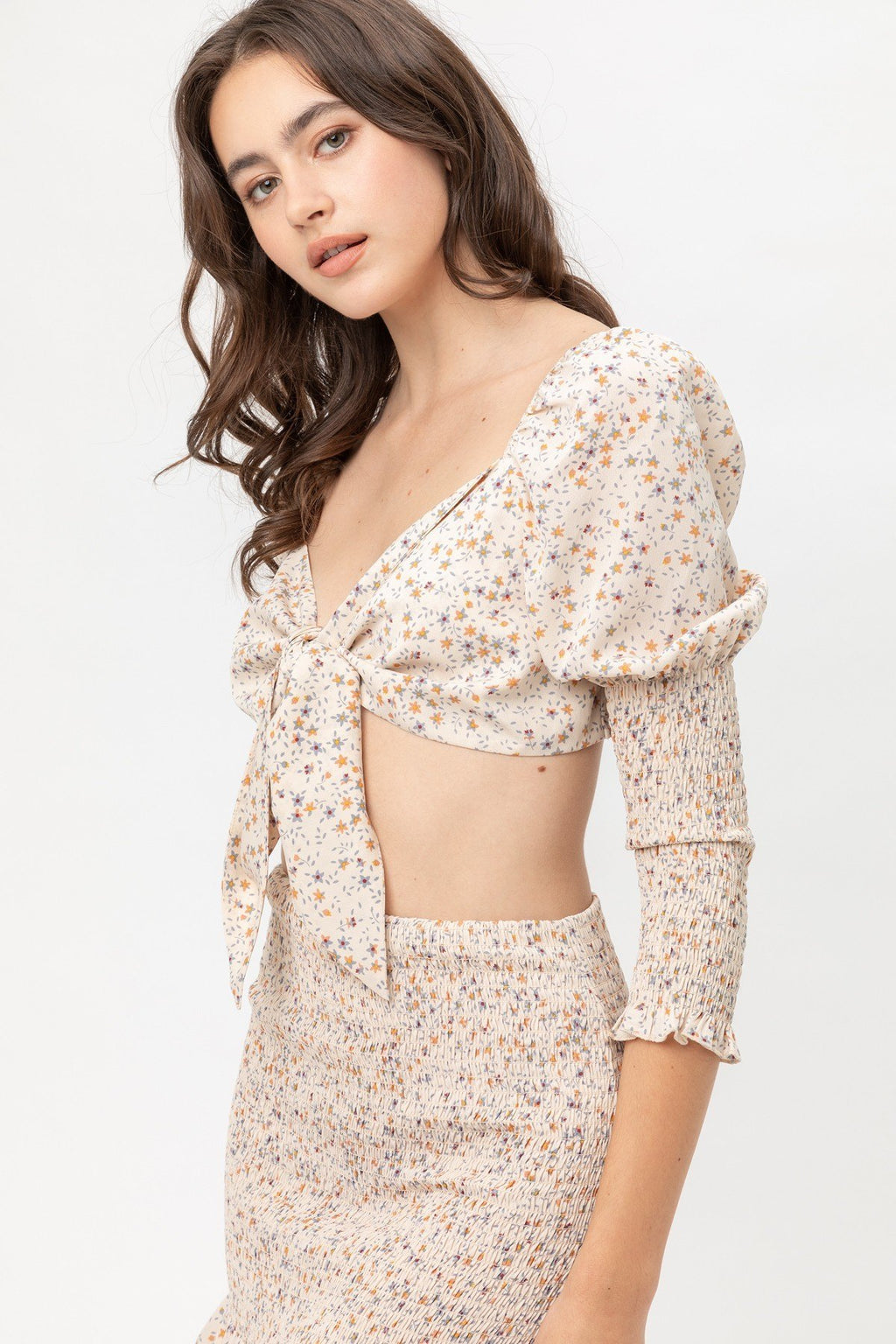 Woven printed top with front bow tie and long puff sleeves, beige