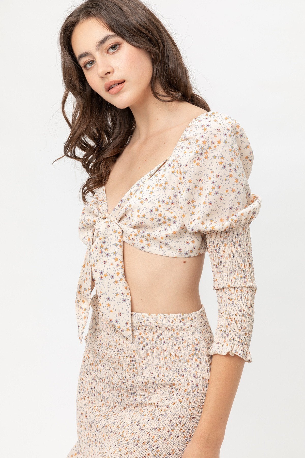 Woven printed top with front bow tie and long puff sleeves, beige