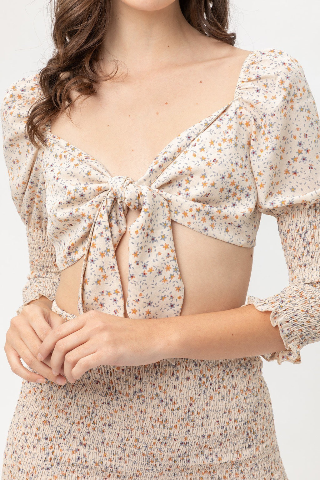 Close-up of front bow tie woven printed top, square neckline and puff sleeves