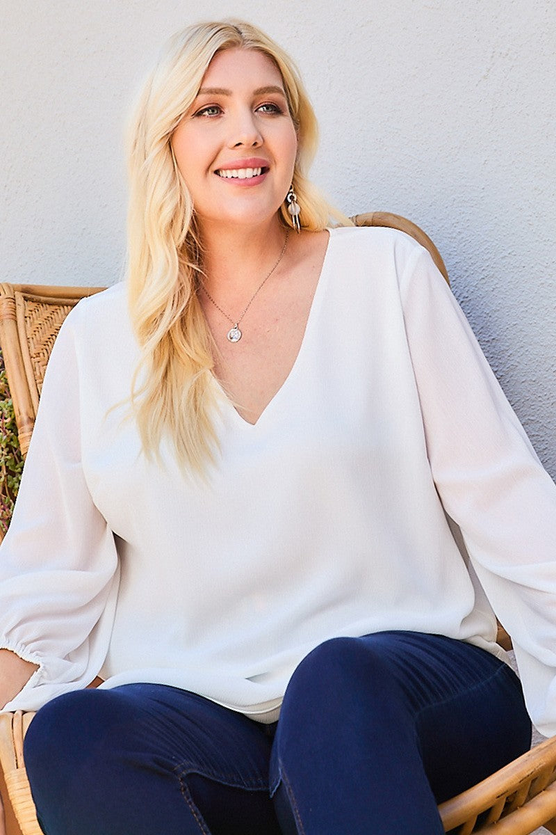 White V-neck bubble-sleeve top with draped neckline and relaxed fit