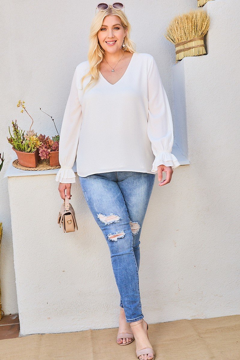 White V-neck tier ruffle sleeve blouse worn with jeans