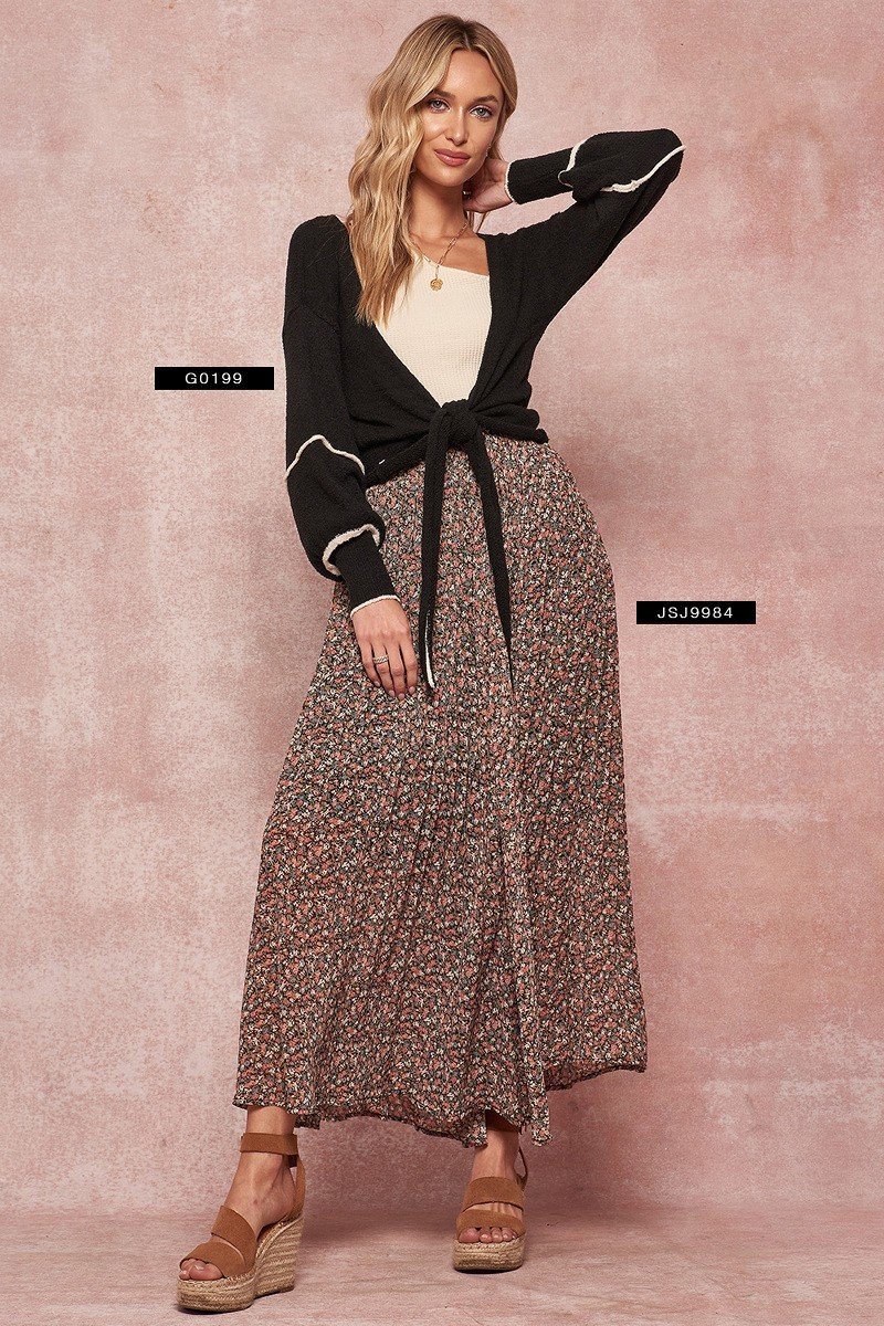 Black cardigan sweater with long sleeves, white-trim cuffs, and tied waist.