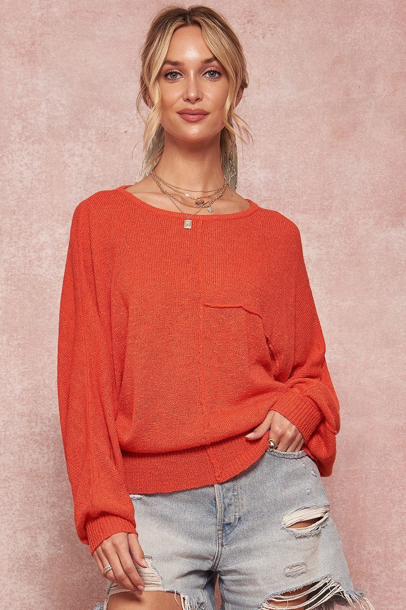 Orange solid knit sweater with boat neckline and long sleeves