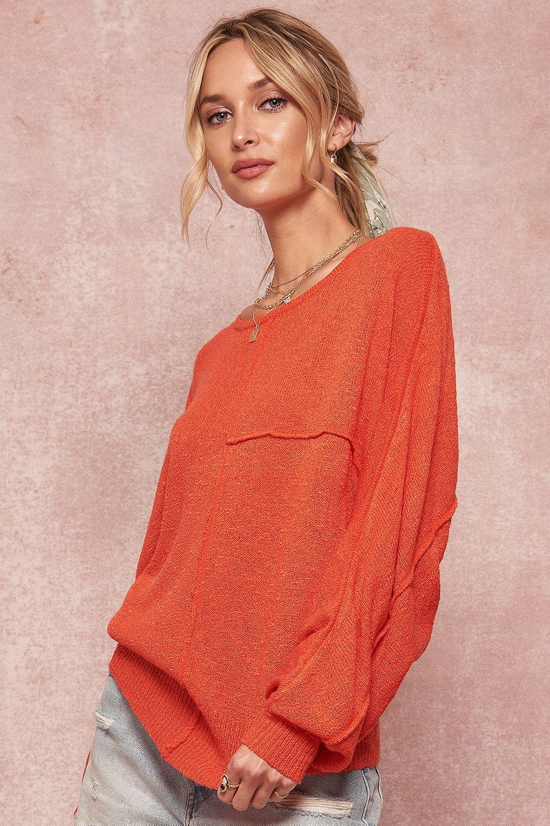 Orange solid knit sweater with dropped hem and long dolman-style sleeves