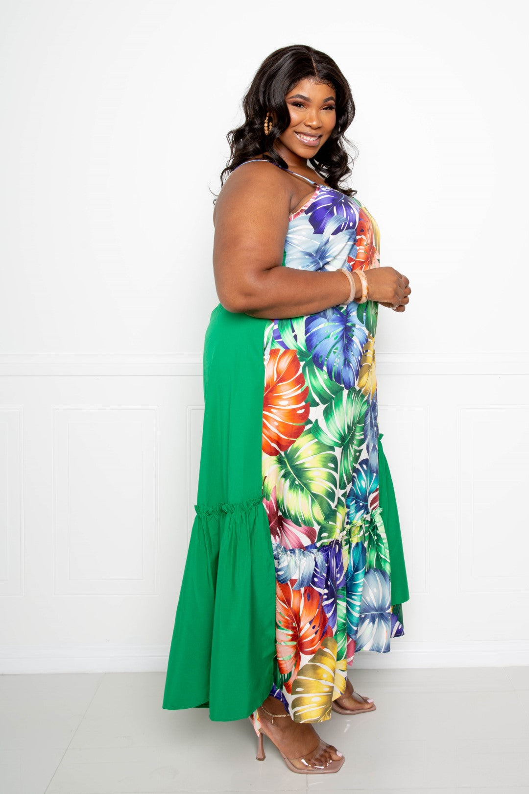 Splice tropical dress side view: multicolor tropical print with green ruffle panel