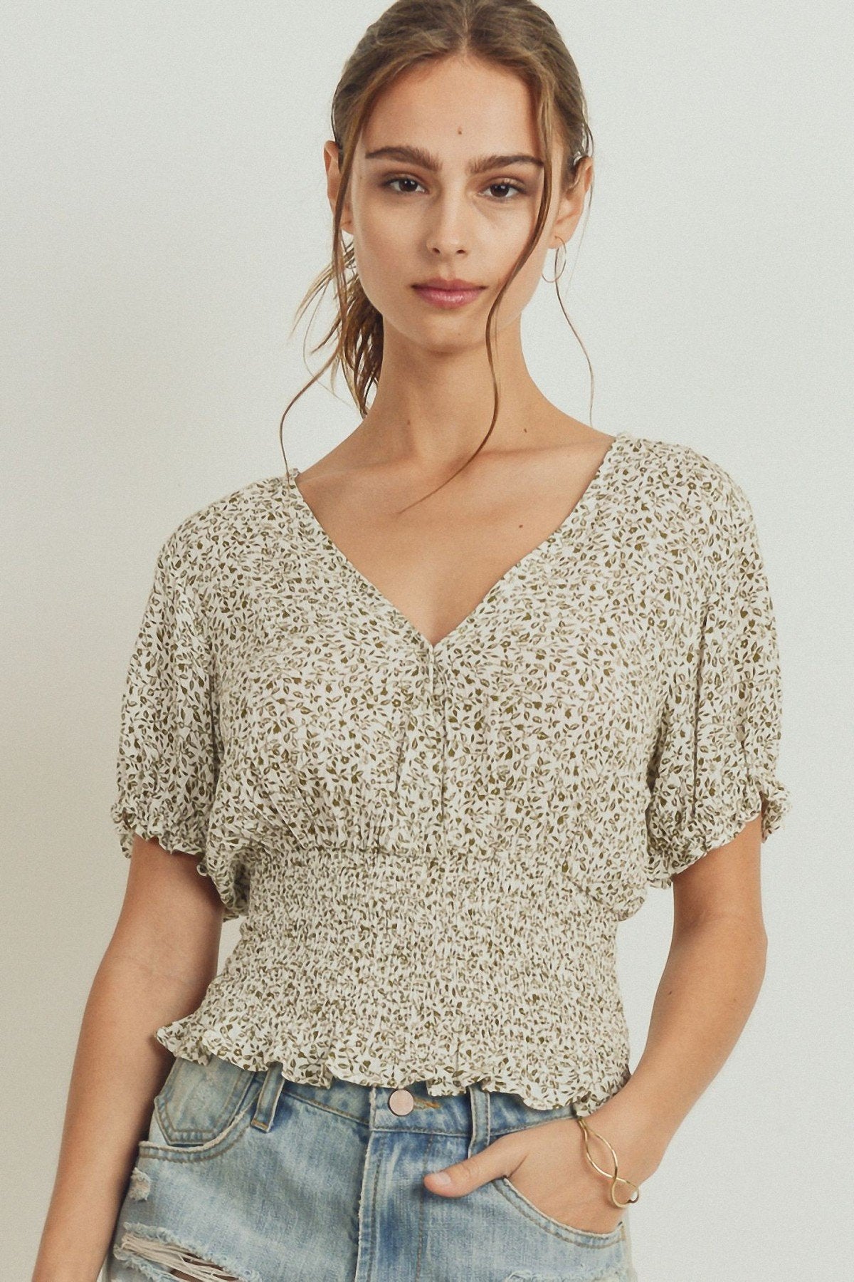 Smocked-waist surplice top with puff sleeves and V-neck, light allover print