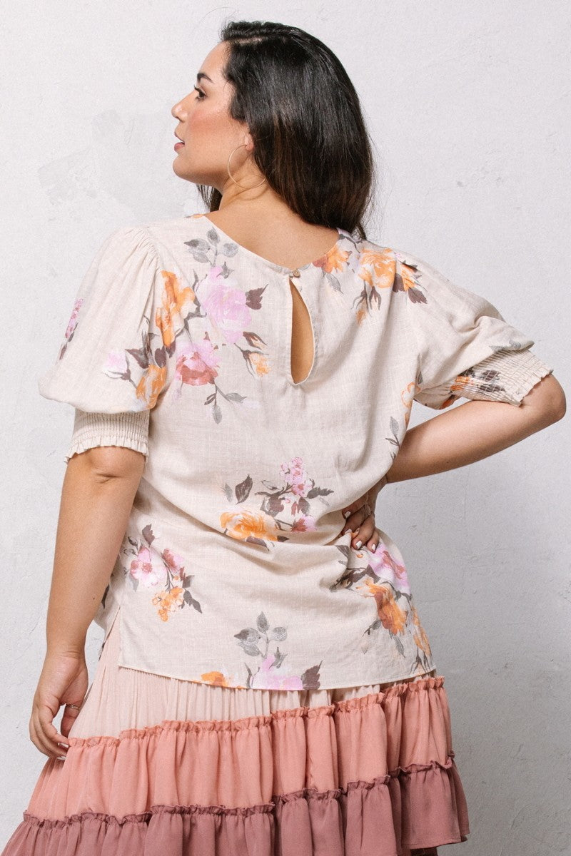 Oatmeal floral blouse back view: keyhole neck and puff sleeves